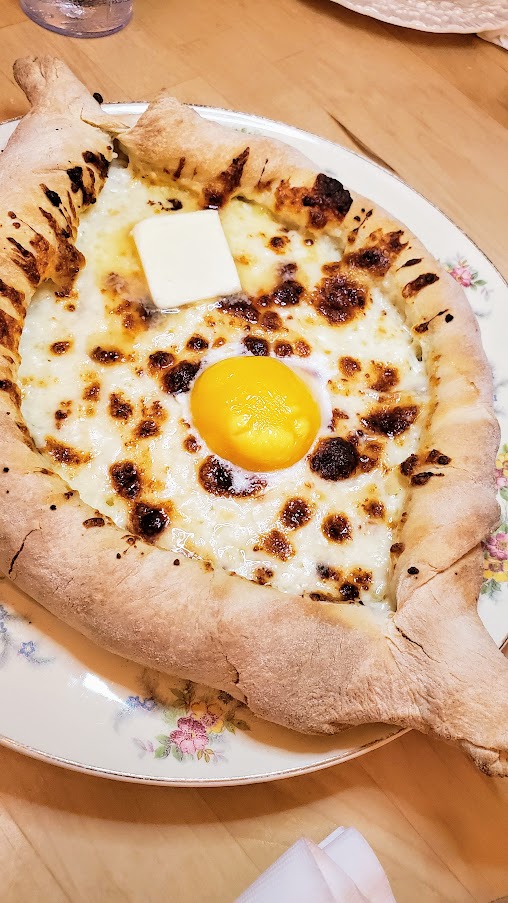 Kargi Gogo Acharuli Khachapuri, an Open-Faced Bread Boat with Cheese, Butter, Easy Egg
