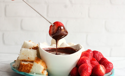 Dipping strawberry into Easy Chocolate Fondue.