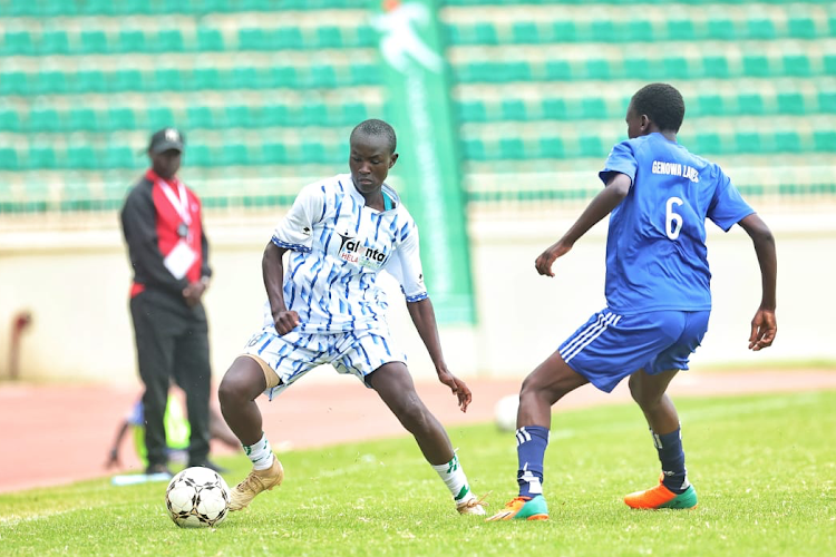 Sharon Vida (left) of Busia battles with Seline Achieng of Homabay during the girls' semifinals of Talanta Hela U19 football tournament at Nyayo stadium.