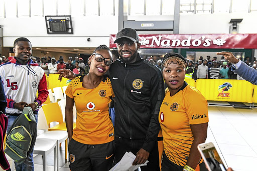 Kaizer Chiefs defender Ramahlwe Mphahlele with supporters during the MTN8 launch at Johannesburg Park Station in yesterday.