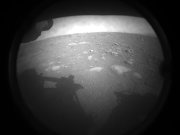 This is the first image Nasa’s Perseverance rover sent back after touching down on Mars. The view, from one of Perseverance’s hazard cameras, is partially obscured by dust cover.