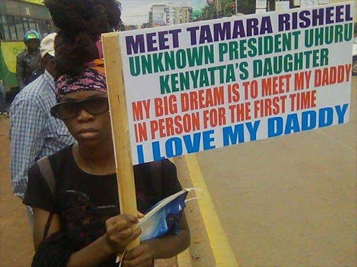 The lady claiming to be President Uhuru's daughter with a sign at Yaya Center on Friday, April 20. COURTESY