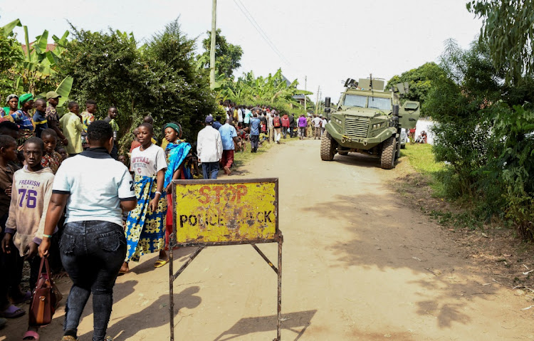 Locals gather at the cordoned scene outside the Mpondwe Lhubirira Secondary School, after militants killed and abducted multiple people, in Mpondwe, western Uganda, on June 17 2023. File photo: REUTERS