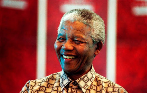 Former President Nelson Mandela of South Africa smiles as he talks to visitors on March 8, 1999 in his residence in Houghton, a suburb of Johannesburg, South Africa.