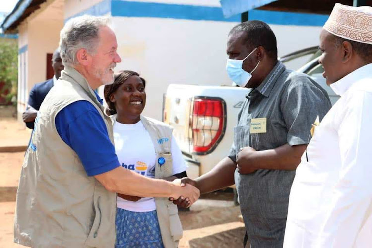 WFP executive director David Beasley is welcomed by Wajir county commissioner Jacob Narengo when led a delegation to assess the drought mitigation preparedness in the county on Tuesday, August 24.