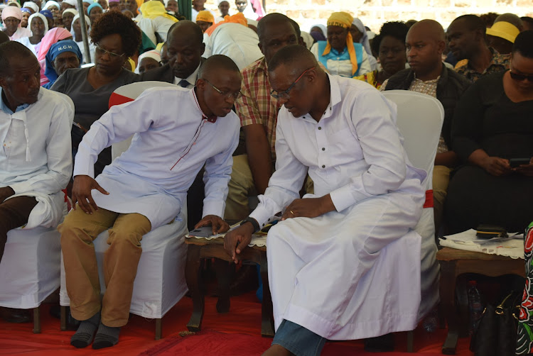 Western region presidential delivery unit director Sylvance Osele consults with CS for ICT & Digital Economy Eliud Owalo at Ayiengo Nomiya church in Kabondo Kasipul constituency on May 5,2024