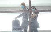 Disembarking passengers don masks at Cape Town International Airport on March 6 2020 amid fears of the coronavirus outbreak.