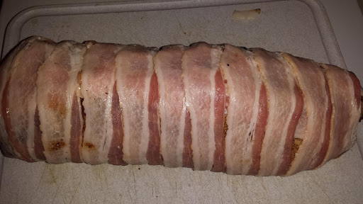 Bacon wrapped around the pork loin roast