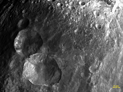 In this image, obtained by the framing camera on NASA's Dawn spacecraft, a set of three craters, informally nicknamed "Snowman" by the camera's team members, is located in the northern hemisphere of Vesta.