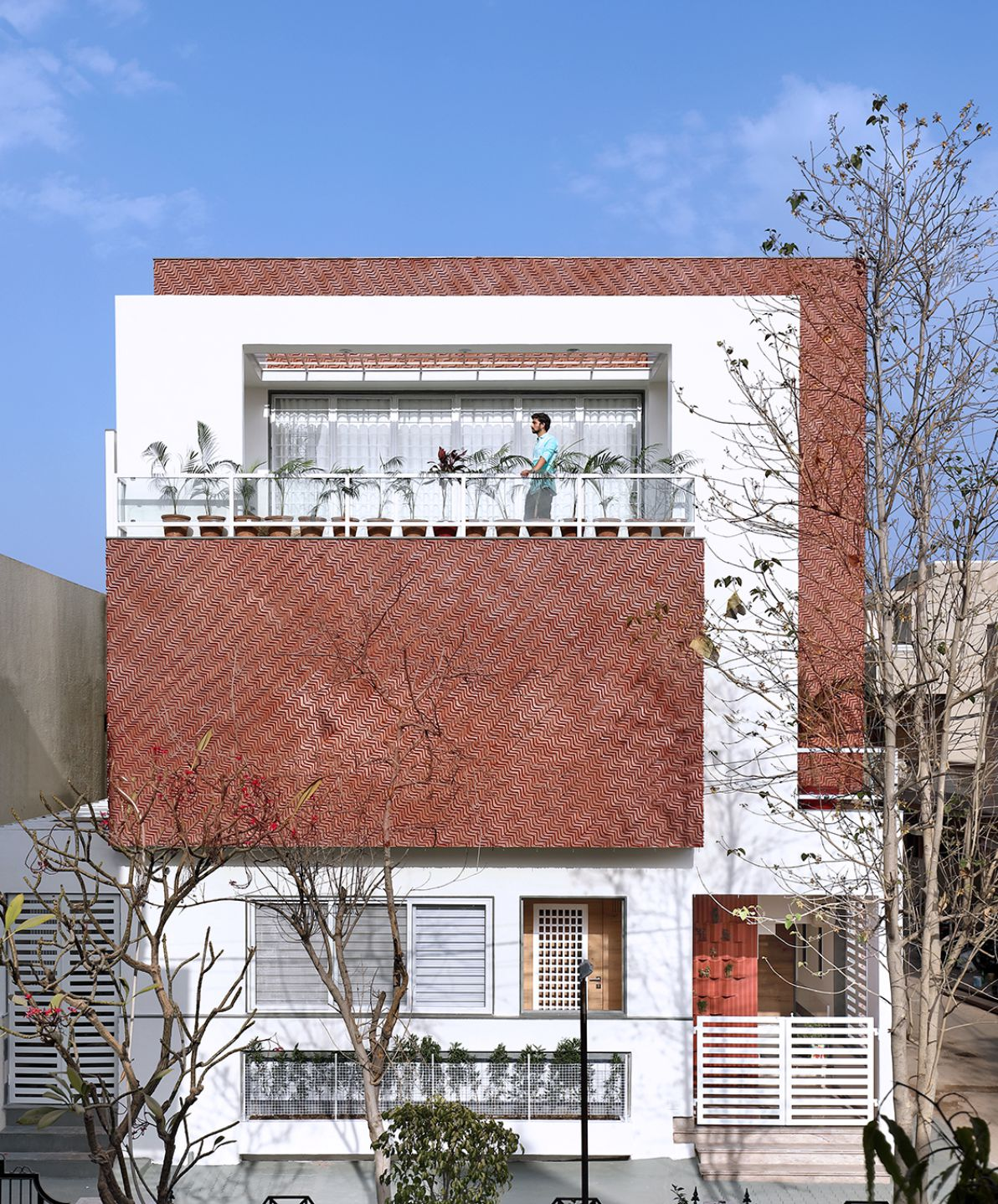 Elevation view of the house by Manoj Patel Design Studio with terracotta facade