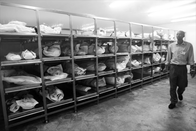 Forensic pathology officers at a facility in Germiston. Covid deaths have been a boon for manufacturers of body bags.