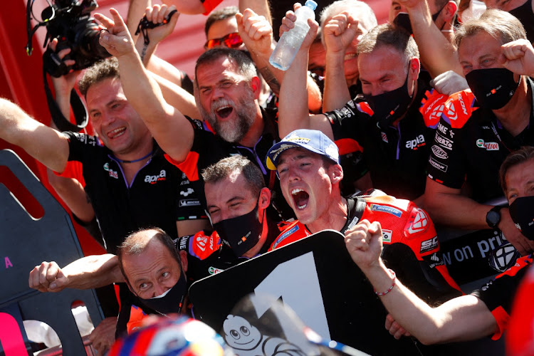 Aprilia Racing's Aleix Espargaro celebrates with teammates after winning the MotoGP of Argentina at Autodromo Internacional, Termas de Rio Hondo on April 3, 2022