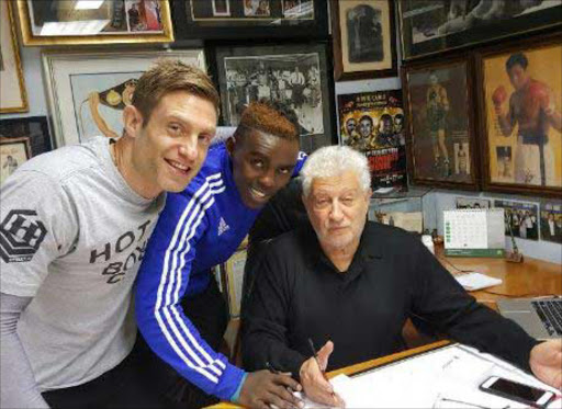 Xolisani Ndongeni with manager Colin Nathan signs the promotional contract with Rodney Berman that will give him rights to co-promote him with top US promoter Art Pelullo Picture: SUPPLIED