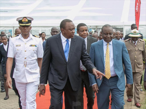 President Uhuru Kenyatta with Finance CS Henry Rotich during the launch of the Regional Electronic Cargo Tracking System (RECTS) and The Integrated Scanner Command Centre at KICC, Nairobi on Wednesday, October 31, 2018. /PSCU