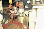 WAITING FOR A HOME:  Lucas Mokgele with his two-year-old daughter Gomolemo  at Tudor Shaft informal settlement.