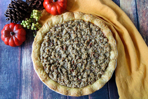 Pumpkin Pie With Cinnamon Pecan Topping ready to be sliced.