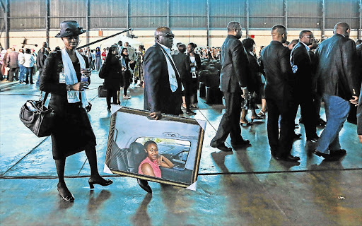 HEAVY LOAD: Family members arrive at Waterkloof Airforce Base in Pretoria yesterday for the reception of the remains of 74 South Africans who died in the collapse of a church building in Nigeria two months ago