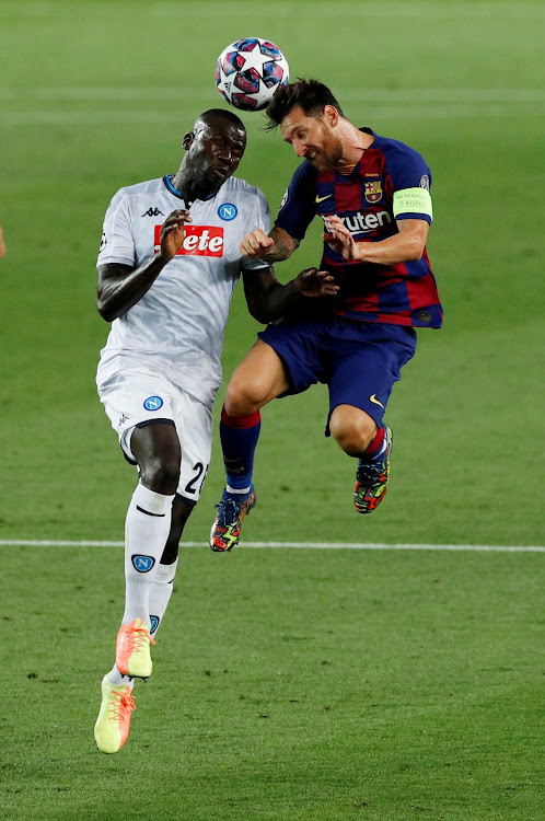 Barcelona's Lionel Messi in action with Napoli's Kalidou Koulibaly