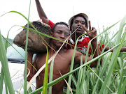 Matsulu residents outside Mpumalanga's capital city celebrate getting meat from three dead elephants.