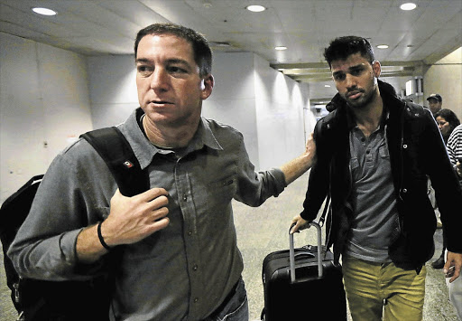 Guardian reporter Glenn Greenwald and his partner David Miranda at Heathrow Airport on Sunday