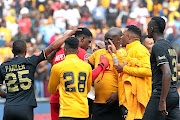 Kaizer Chiefs goalkeeper Daniel Akpeyi is mobbed by  teammates, including Itumeleng Khune, after their win over Orlando Pirates at FNB Stadium, where Akpeyi was man of the match. /ANTONIO MUCHAVE