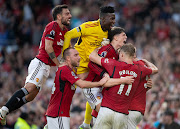 Scott McTominay of Manchester United celebrates scoring the winning goal with teammates Bruno Fernandes, Andre Onana, Christian Eriksen, Alejandro Garnacho, Rasmus Hojlund and Harry Maguire during their Premier League match against Brentford at Old Trafford.