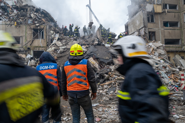 Emergency workers search the remains of a residential building that was struck by a Russian missile in Dnipro, Ukraine, January 15 2023. Picture: SPENCER PLATT/GETTY IMAGES