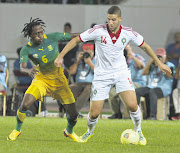 BATTLEFIELD: South Africa's Lerato Chabangu fights for the ball with Morocco's Adel Taarabt during their international friendly at Stade Adrar in Agadir, Morocco, on Friday. Bafana coach Gordon Igesund praised his young team for the 1-1 draw.