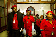 EFF leader Julius Malema and members of the EFF leave the National Assembly during a debate on President Jacob Zuma's state of the nation address in Parliament.