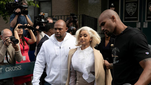 Cardi B leaving NYC police station alongside his body guards