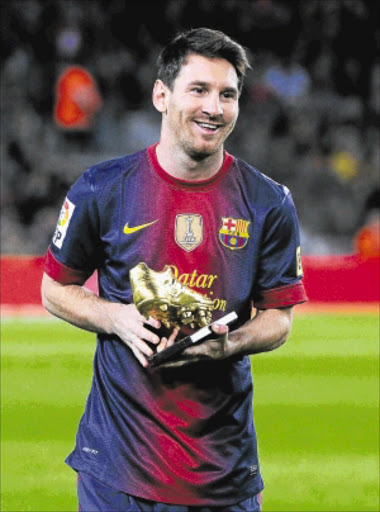 Barcelona playmaker Lionel Messi holds the European Golden Boot 2012 trophy Photo: Getty Images