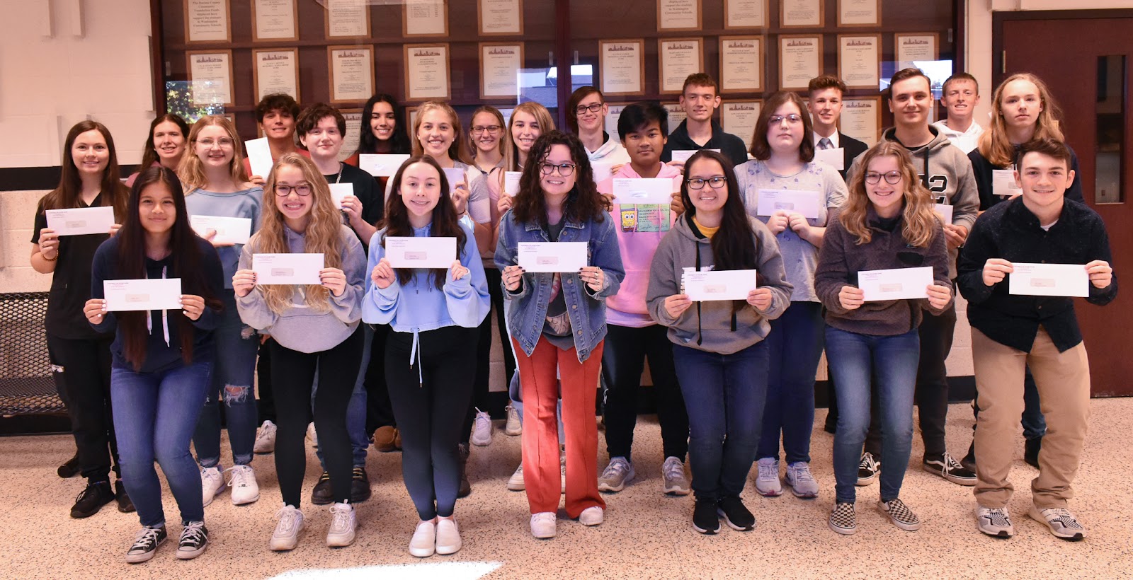 kids posing with checks