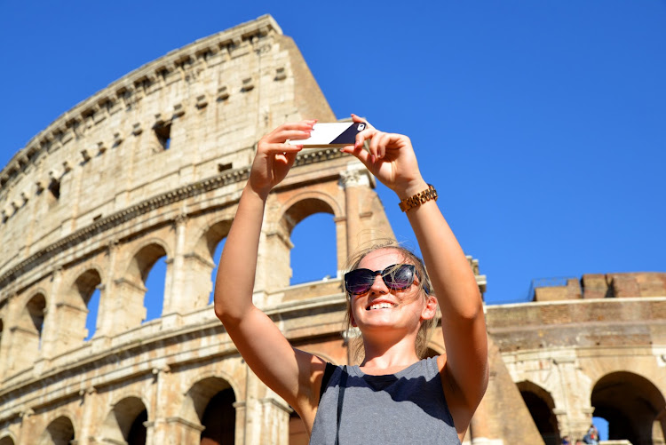 Stick to the selfies and avoid tourist traps at the Colosseum in Rome. Stock photo.