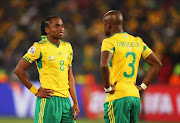 Siphiwe Tshabalala and Tsepo Masilela of South Africa are dejected after defeat in the 2010 FIFA World Cup South Africa Group A match between South Africa and Uruguay at Loftus Versfeld Stadium on June 16, 2010 in Tshwane/Pretoria, South Africa. 