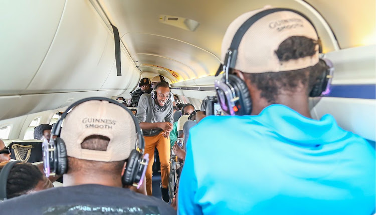 Brian Kimanzi dances on board the jet.