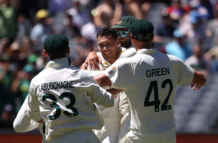 Australia's Scott Boland celebrates taking the wicket of England's Mark Wood with teammates in the third Test at Melbourne Cricket Ground on December 28, 2021