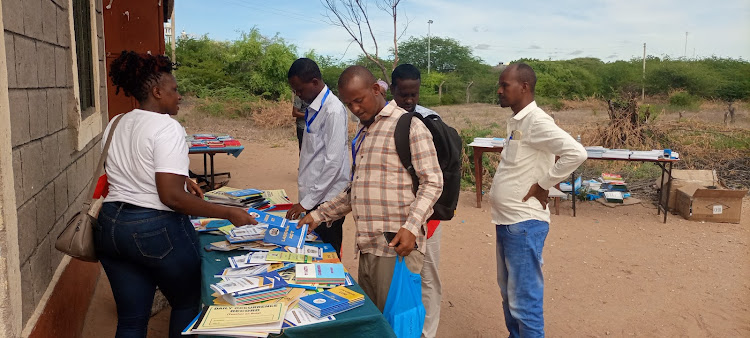 Head Teachers from North Eastern sample books during the Kepsha meeting at Garissa Primary School