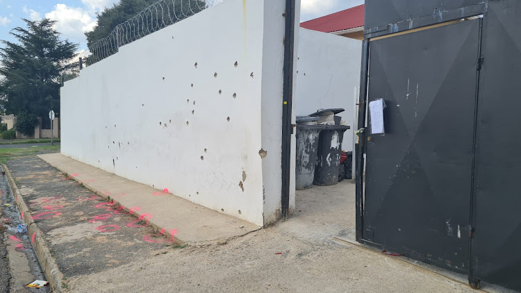 The wall around a house in Friars Hill Road in Rosettenville which suspected CIT robbers were using as a hideout. Bullet holes and pink markers on the pavement remain after a fierce gun battle between the robbers and police on Monday.