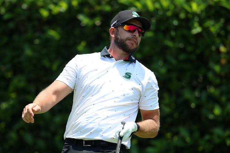 Dean Burmester reacts as he tees off on the second hole at Houghton on Sunday.