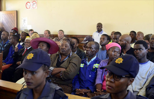 Father of the murdered Coligny boy Matlhomola Faku Moshweu, Sakie Dingake (Blue Overall) sitting inside the Coligny Magistrate court before the court proceedings. Photo: Tiro Ramatlhatse