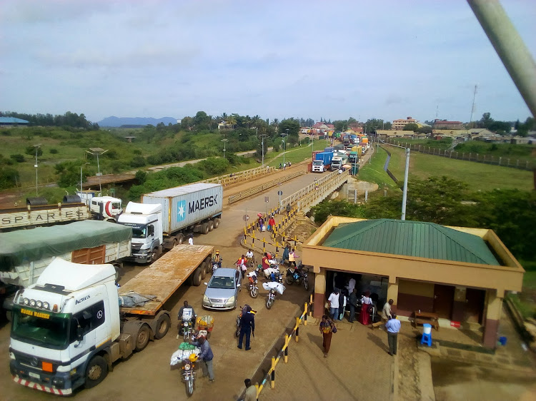 Trucks cross the Malaba border into Kenya. The border had partially been closed on Sunday.