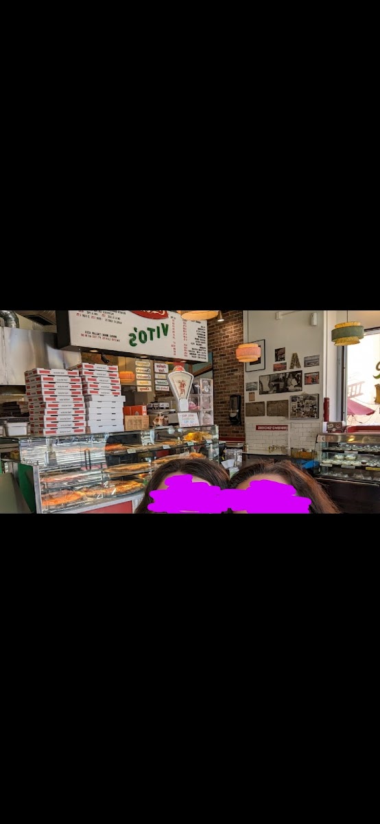 Selfie from the counter seats, showing pizza behind.  Note: GF pizza stored in same area