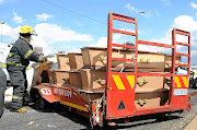 A trailer that was coffins of paupers broke down and lost both its wheels on the M1 South en route to Olifantsvlei Cemetry, South of Johannesburg.Picture: