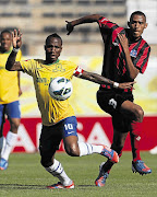 Teko Modise of Sundowns stretches every muscle in the fight for three points against United's Mario Booysen in their PSL encounter at Lucas Moripe stadium in Atteridgeville, Pretoria yesterday Picture: SYDNEY SESHIBEDI