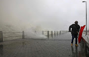 A man dodges a wave as severe weather hit the shores of Cape Town this afternoon.