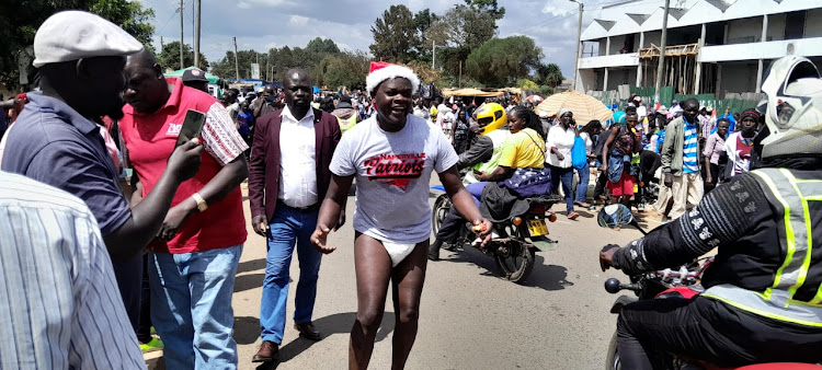 Musician William Getumbe wearing diappers during the street campaigns in Eldoret on December 23rd 2022