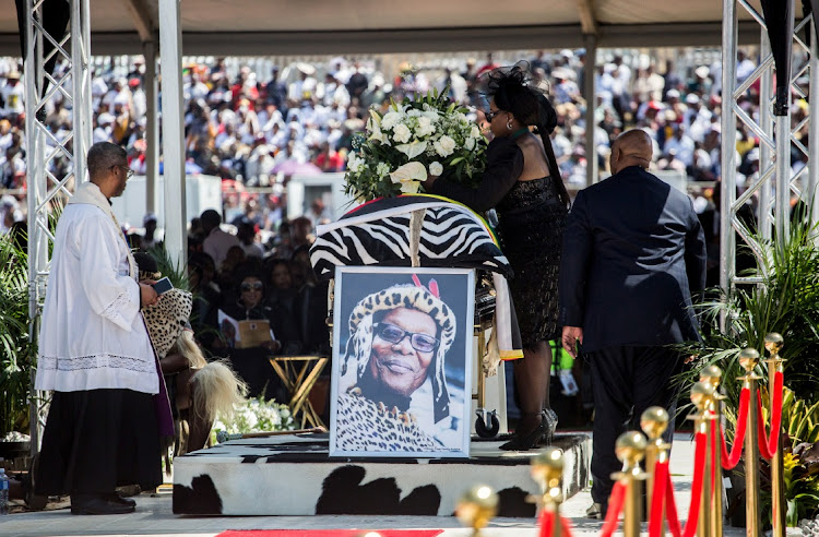 A mourner places flowers on the coffin of Prince Mangosuthu Buthelezi in Ulundi. Picture: MLUNGISI MBELE