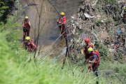 A rescue team combs the Jukskei River for the bodies of congregants who lost their lives during a baptism ceremony.. File photo. 