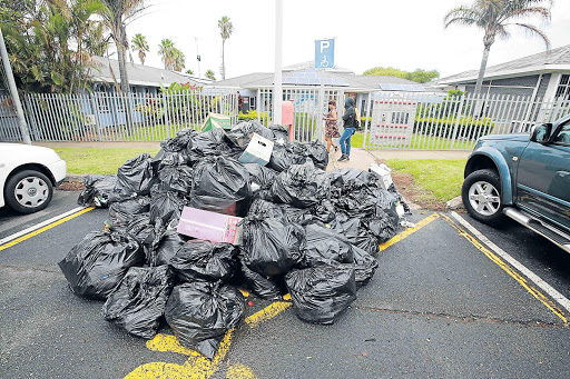 WHAT A MESS: Refuse is spread across the main road in Duncan Village. Residents resorted to burning a mountain of uncollected rubbish this week Picture: FACEBOOK