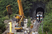 A crane lifts the wreckage of a truck which was hit by the train a day after the deadly train derailment at a tunnel north of Hualien, Taiwan April 3, 2021. 